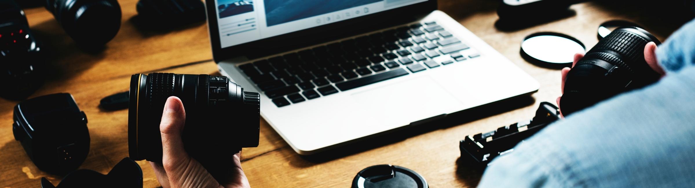 Web application development workspace showing camera lens technology and laptop used in Konica Minolta partner portal project