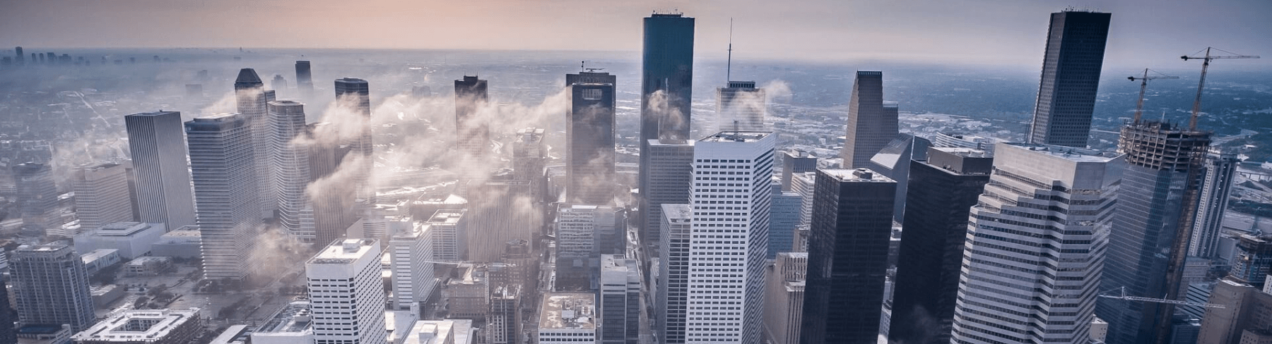 Aerial view of Houston Texas skyline at sunrise representing the competitive legal market where Enlimited delivered 300% more conversions for a personal injury law firm