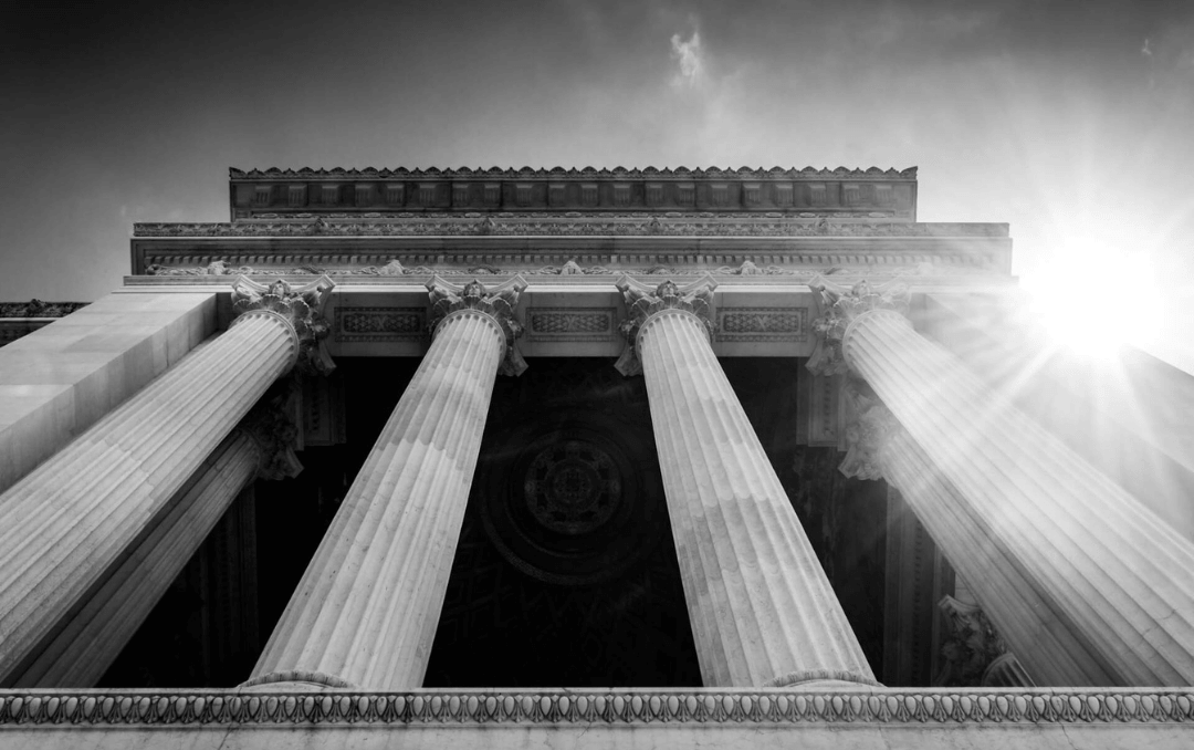 Black and white courthouse columns representing legal authority and trust built through Enlimited's law firm marketing strategy for a Houston personal injury firm